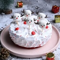 Red Velvet Cake with Mini Christmas Figurines – The perfect holiday cake decorated with miniatures for the season.