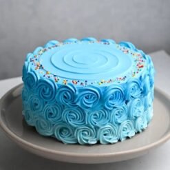 Round blue cream layer cake with smooth frosting for birthdays and celebrations.