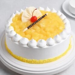 Pineapple Whipped Cream Cake with smooth whipped cream frosting and fresh pineapple pieces