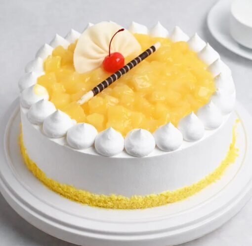 Pineapple Whipped Cream Cake with smooth whipped cream frosting and fresh pineapple pieces