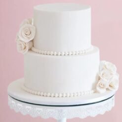 Luxurious Pearly White Floral Cake with tire-shaped cream decoration and floral details