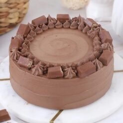 Delicious Kit Kat Crunch Cake featuring layers of cream and Kit Kat chocolate bars