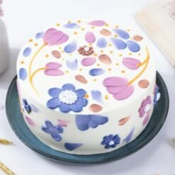 Close-up of Floral Bliss Cake showcasing colorful floral accents and a moist cake base