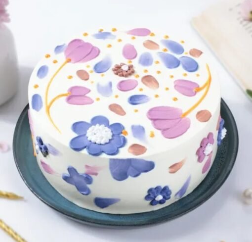 Close-up of Floral Bliss Cake showcasing colorful floral accents and a moist cake base