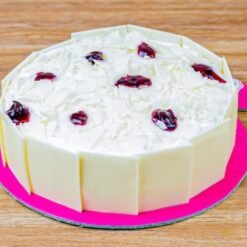 Tempting Whiteforest Cake decorated with creamy layers and topped with cherries