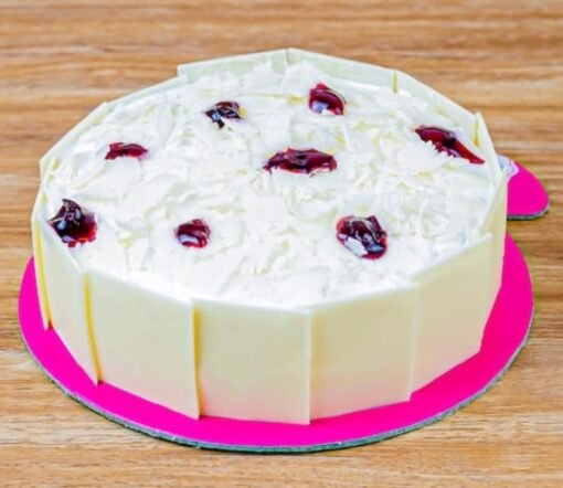 Tempting Whiteforest Cake decorated with creamy layers and topped with cherries