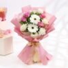 A graceful bouquet featuring blushing roses and cheerful gerberas, elegantly arranged for a stunning floral display.