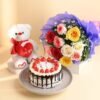 A charming gift set featuring a beautiful floral arrangement, a soft teddy bear, and a delectable cake, perfect for special occasions.