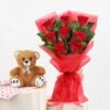 Beautiful bouquet of scarlet red roses with a cuddly teddy bear, an ideal gift for love, anniversaries, and special moments.