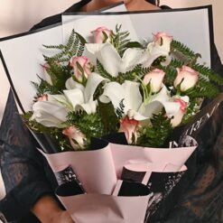 A beautifully arranged Lush Lily & Rose Grace Bouquet with delicate lilies and roses, radiating elegance and charm.
