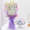 A graceful bouquet of fresh white orchids with a delightful cake, ideal for special occasions and thoughtful gifting.