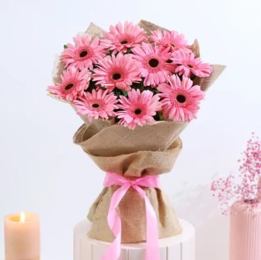 A stunning bouquet of rosy gerberas and fresh roses, arranged beautifully to create a charming and elegant floral symphony.