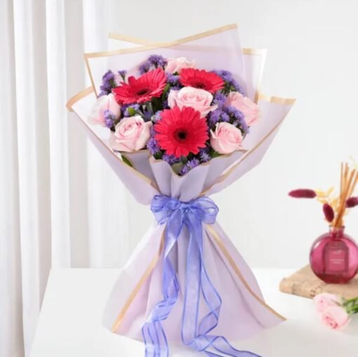 Elegant Rosy Glow & Gerbera Magic bouquet featuring vibrant roses and gerberas, creating a dazzling floral display for special moments.