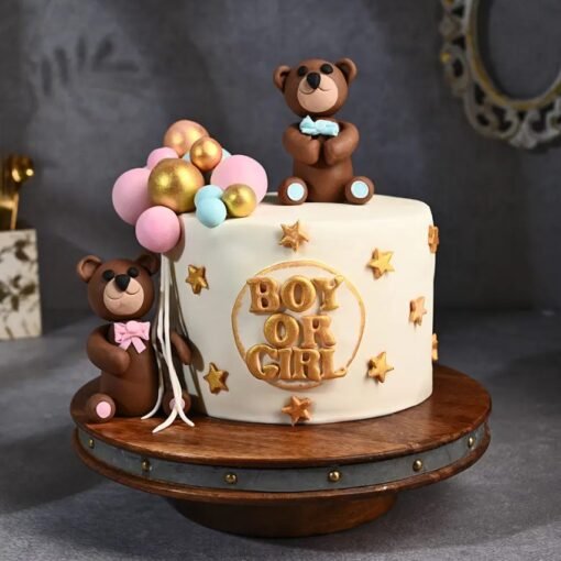 Cute gender reveal cake with pink and blue decorations for baby announcement.