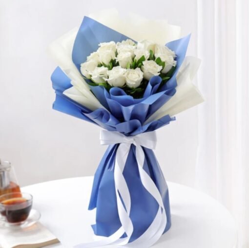A romantic bouquet of soft-hued roses and seasonal flowers elegantly wrapped, symbolizing gentle love and affection.