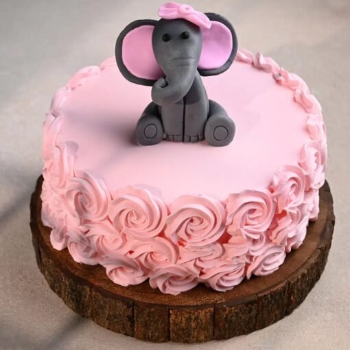 Fondant cake with a smiling baby elephant topper and pastel decorations, ideal for baby showers or 1st birthdays.