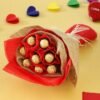 Bouquet of Ferrero Rocher chocolates wrapped in luxe gold and soft floral paper, tied with a satin ribbon.