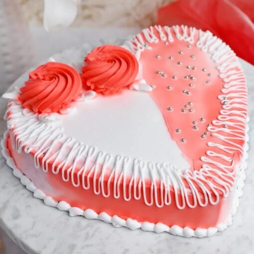 Heart‑shaped orange sponge cake topped with mixed berries, candied orange slices, and glossy glaze.