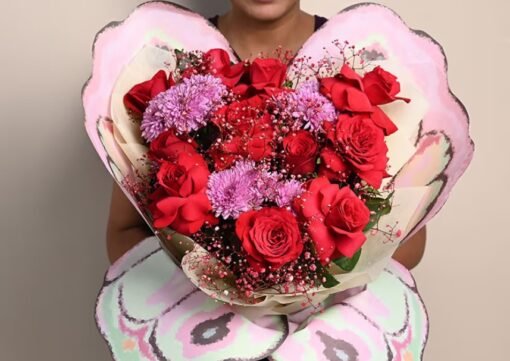 Romantic bouquet of scarlet red roses with soft blush accents.