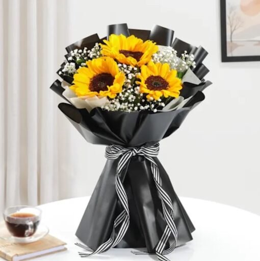 Fresh sunflower bouquet with vibrant yellow petals and lush green leaves, beautifully arranged and wrapped.