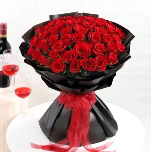 Elegant bouquet of vibrant red roses wrapped in rich packaging, symbolizing fiery love and sophistication.