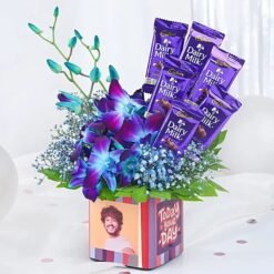 Blue orchids with Dairy Milk chocolate combo – elegant floral and sweet gift set.