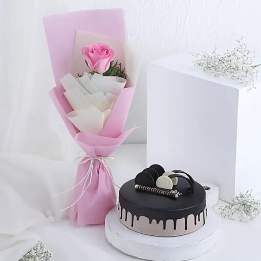 Blushing pink roses paired with a rich chocolate cake in a romantic gift combo.