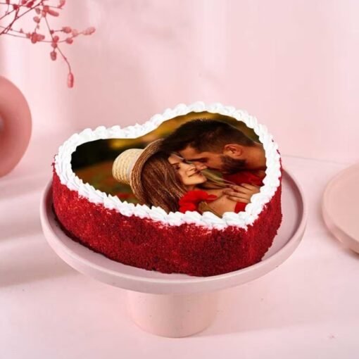 Heart-shaped red cake with a customizable photo on top, ideal for romantic occasions.