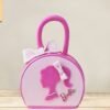 Barbie-themed handbag cake with pink fondant, elegant detailing, and chic fashion-inspired design.
