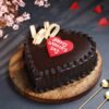 Heart-shaped truffle cake decorated for Women’s Day with chocolate ganache and elegant accents.