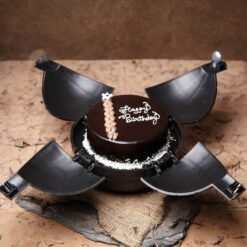 Chocolate bomb cake with a hammer, ready to be smashed to reveal treats inside.