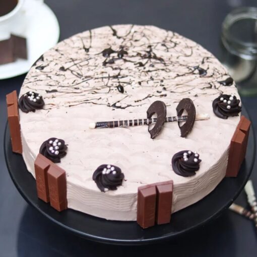 KitKat Truffle Cake decorated with KitKat bars and chocolate ganache.