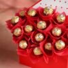Bouquet of Ferrero Rocher chocolates wrapped in luxe black‑and‑gold paper and tied with a satin ribbon.