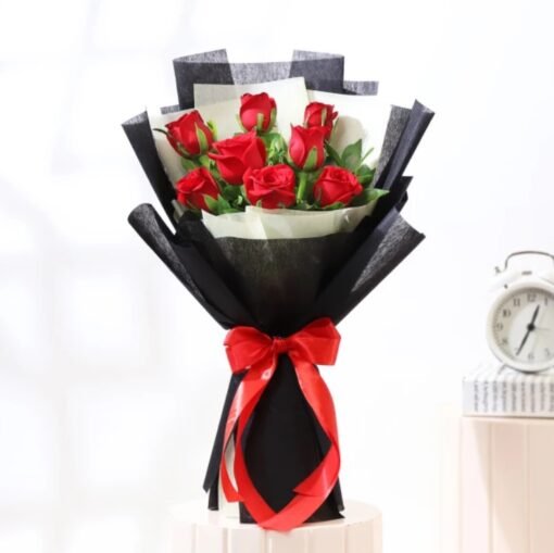 Elegant bouquet of red and pink roses wrapped in soft pastel paper, symbolizing warmth and affection.