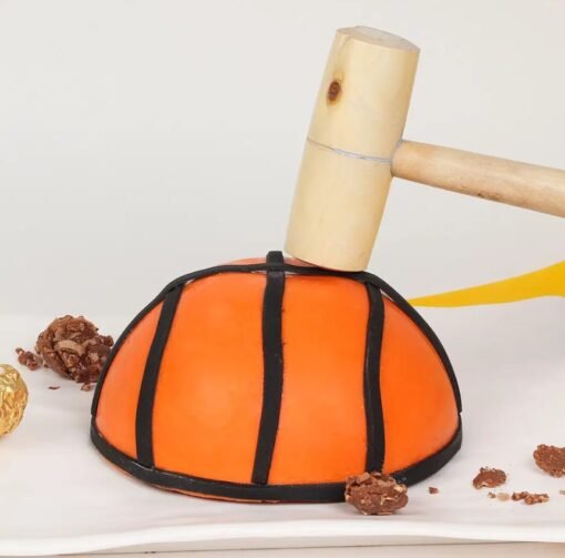 Basketball-themed pinata cake designed like a real basketball, filled with candies and treats.