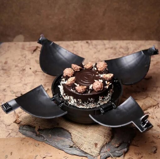 Ferrero Rocher Bomb Cake with a chocolate shell and Ferrero Rocher chocolates hidden inside for a sweet surprise.