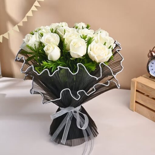 Elegant rose bouquet featuring a harmonious mix of soft pink, red, and white roses in a graceful floral arrangement.