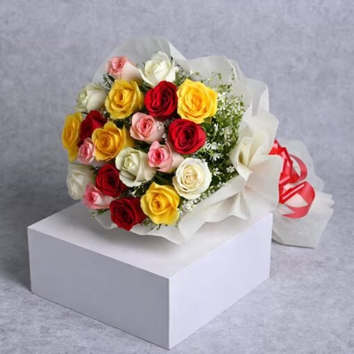 Bright rainbow-colored bouquet featuring roses and mixed seasonal flowers in vivid shades.
