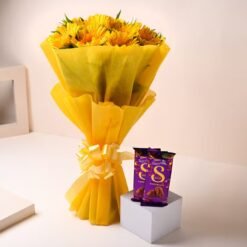 Yellow flower bouquet with assorted chocolates arranged beautifully.