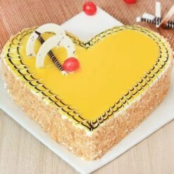 Heart-shaped butterscotch cake topped with caramel drizzle, praline bits, and creamy swirls.