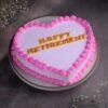 Heart-shaped retirement celebration cake decorated with elegant designs and a heartfelt message.