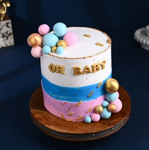 Gender reveal cake with “Oh Baby!” topper and hidden pink or blue filling inside.