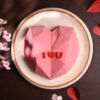 Pink heart-shaped pinata cake filled with candies and surprises, decorated for special celebrations.