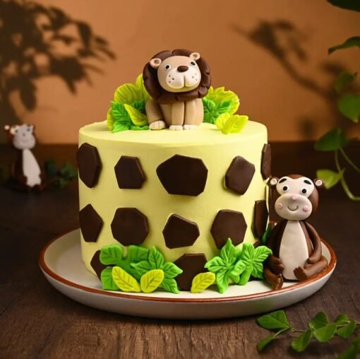Jungle-themed birthday cake with a fondant lion topper, trees, and vibrant safari elements for a wild celebration.