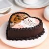 Heart-shaped red and white cream cake with love-themed decorations, symbolizing romance and commitment.