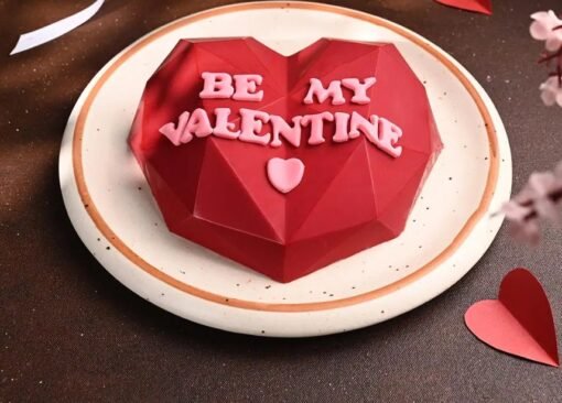 Romantic heart-shaped Valentine’s pinata cake with red and pink decor, filled with surprise treats inside.