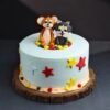Tom and Jerry-themed cake with fondant figures of the cat and mouse duo, cartoon elements, and colorful birthday decorations.