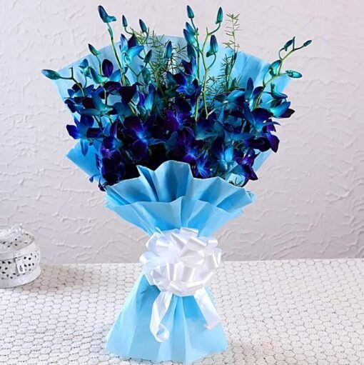 Bouquet of blue and white orchids arranged beautifully with ocean-inspired wrapping.
