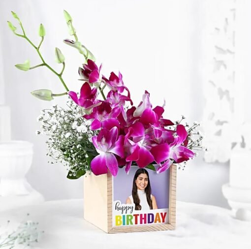 Lavender and white orchids artistically arranged in a custom wooden organiser with a single compartment for pens or gadgets.