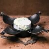 Crack The Crave chocolate bomb cake with a hammer, filled with assorted candies and treats inside.